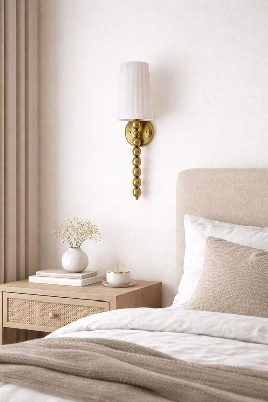 Modern classic brass wall sconce with pleated fabric shade for elegant presence